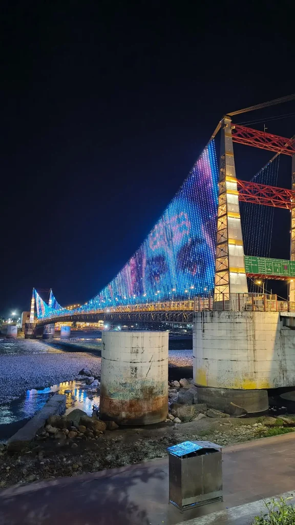 Beautiful night view of Janki Setu illuminated over the Ganga River in Rishikesh